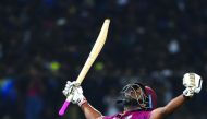 West Indies' batsman Andre Russell celebrates after scoring the winning run to defeat Sri Lanka by seven wickets during the second Twenty20 international cricket match of a two-match series between Sri Lanka and West Indies at the Pallekele International 