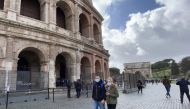 People wear face masks as a precaution not to being exposed to the coronavirus walking around Collesium in Rone, Italy on March 6, 2020. Bar?? Seçkin - Anadolu