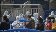 People who have recovered from the COVID-19 coronavirus infection leave Wuchan makeshift hospital in Wuhan in China's central Hubei province on March 10, 2020. / AFP / STR