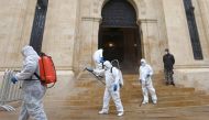 Sanitary workers disinfect the entrance of the Lebanese Parliament in central Beirut on March 10, 2020, amid the spread of coronavirus in the country. / AFP / ANWAR AMRO