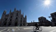 A person rides a bicycle past Milan Cathedral on the second day of an unprecedented lockdown across all of the country, imposed to slow the outbreak of coronavirus, in Milan, Italy March 11, 2020. Reuters/Flavio Lo Scalzo