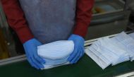 An employee wearing a facemask amid concerns of the spread of the COVID-19 coronavirus works at the production line of facemasks at Salus Products, a manufacturer of surgical disposable products, on the outskirts of Ahmedabad on March 12, 2020. AFP / Sam 