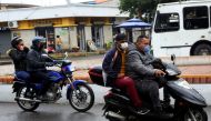  People on motorcycles wear face masks near the Venezuelan-Colombia border after the Colombian government decided to close the Simon Bolivar international bridge as a preventive measure in response to the spreading coronavirus disease (COVID-19) in San An