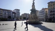 Police officers cross a virtually deserted square, amidst concerns over Spain's coronavirus outbreak, in the Basque city of Vitoria, Spain, March 14, 2020. REUTERS/Vincent West