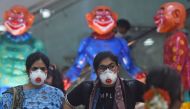  Passengers wearing facemasks amid concerns over the spread of the COVID-19 novel coronavirus, walk inside the airport in Goa on March 15, 2020. (AFP / Punit PARANJPE)