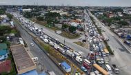 This aerial photo shows traffic congestion from vehicles waiting to clear checkpoints, part of measures to reduce the spread of the COVID-19 pandemic, before entering Manila on March 16, 2020. AFP / Ron LOPEZ