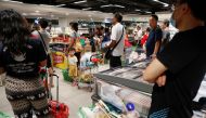 People buy food at a supermarket amid fears of a disruption in supplies after Malaysia announced the closure of its borders following the coronavirus outbreak in Singapore, March 17, 2020. REUTERS/Edgar Su