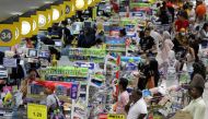 People line up to pay at a supermarket amid fears of a disruption in supplies after the Malaysia's government announces a restricted movement order imposed on March 18 due to the spread of the coronavirus disease, in Subang Jaya, Malaysia, March 17, 2020.