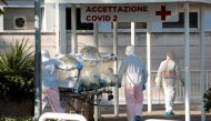 Medical workers in protective suits push an isolation stretcher in front of the Columbus Clinic, where patients suffering from coronavirus disease (COVID-19) were moved from Spallanzani Hospital, in Rome, Italy March 16, 2020. Reuters/Remo Casilli
 
 
