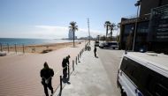 Police officers place tape to close to the public the Barceloneta beach area, amidst concerns over Spain's coronavirus outbreak, in Barcelona, Spain March 15, 2020. REUTERS/Nacho Doce
