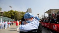 A local medical worker embraces and bids farewell to a medical worker from Jiangsu at the Wuhan Railway Station as the medical team from Jiangsu leaves Wuhan, the epicentre of the coronavirus disease (COVID-19) outbreak, in Hubei province, China March 19,