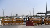 Incoming traffic to Delhi is stopped by policemen at a checkpoint at the Uttar Pradesh and Delhi border along the Delhi-Meerut Expressway to inforce a lockdown order by Delhi's government as a preventive measure against the COVID-19 novel coronavirus, in 