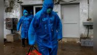 Volunteers of the Edhi Foundation, a non-profit social welfare programme, wear raincoats and boots as they pose during a mock drill on handling suspected carriers of the coronavirus disease (COVID-19), in Karachi, Pakistan March 26, 2020. REUTERS/Akhtar S