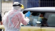 A health worker at a drive-thru coronavirus disease (COVID-19) testing center in Lisbon, Portugal, March 26, 2020. REUTERS/Rafael Marchante