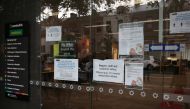 Signs on social distancing and the coronavirus disease (COVID-19) are seen outside a Centrelink office in Sydney, in the wake of New South Wales implementing measures shutting down non-essential businesses and moving toward harsh penalties to enforce self