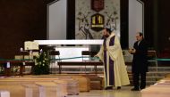 Priest Don Marcello blesses the coffins lined up in the church of San Giuseppe, waiting to be brought to the crematorium by the Italian military on March 28, 2020 in Seriate, Italy. (Pier Marco Tacca / Anadolu Agency)