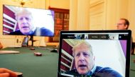 Boris Johnson appears on monitors for COVID-19 meeting in London, Britain March 28, 2020. Andrew Parsons/10 Downing Street/Handout via Reuters