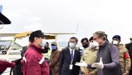 In this handout photograph taken and released by the Pakistan's Press Information Department (PID) on March 28, 2020, Pakistan's Foreign Minister Shah Mehmood Qureshi (R) greets Chinese doctors upon their arrival at the Islamabad International airport in 
