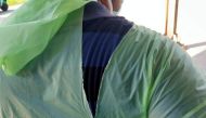 A doctor wearing a torn raincoat stands at the major coronavirus disease (COVID-19) treatment facility amid concerns about the spread of the disease in Kolkata, India, March 26, 2020. Picture taken March 26, 2020. REUTERS/Stringer