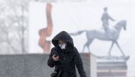 MOSCOW, RUSSIA - MARCH 31: A woman wearing a medical mask during a snowfall at Red square after preventive measures against the coronavirus (Covid-19) are taken in Moscow, Russia on March 31, 2020. ( Sefa Karacan - Anadolu Agency )