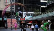 People walk by an area of the city following the implementation of stricter social-distancing and self-isolation rules to limit the spread of the coronavirus disease (COVID-19) in Sydney, Australia, March 31, 2020. REUTERS/Loren Elliott