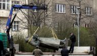 The statue of Soviet World War II commander Ivan Stepanovic Konev is loaded on a truck after removal from its platform in Prague, Czech Republic, April 3, 2020. REUTERS/David W Cerny
