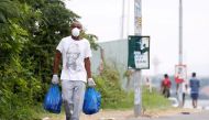 FILE PHOTO: A man carries home groceries during a nationwide 21 day lockdown in an attempt to contain the coronavirus disease (COVID-19) outbreak in Umlazi township near Durban, South Africa, March 31, 2020. REUTERS/Rogan Ward