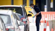 NHS workers check people at a coronavirus (COVID-19) drive-through testing station set up at the Wembley IKEA store for NHS staff on April 1, 2020 in London, United Kingdom. Kate Green - Anadolu 
