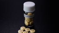 FILE PHOTO: Tablets of Avigan (generic name : favipiravir), a drug approved as an anti-influenza drug in Japan and developed by drug maker Toyama Chemical Co, a subsidiary of Fujifilm Holdings Co. are displayed during a photo opportunity at Fujifilm's hea