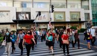Pedestrians wearing protective face masks cross a street outside a shopping mall amid new cases of coronavirus, in Manila, Philippines, March 11, 2020. REUTERS/Eloisa Lopez