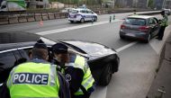 French police check motorists' outings authorisation on an access to Paris' ring-road on April 11, 2020 during the 26th day of a strict confinement in France aimed at curbing the spread of the COVID-19 disease caused by the novel coronavirus. / AFP / Thom