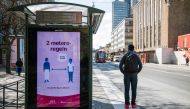 An advertisement of the healthcare services of Sweden instructs people to follow the 2 meters rule to reduce the risk of getting sick, in Stockholm on April 14, 2020. / AFP / Jonathan NACKSTRAND