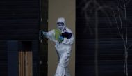 A medical specialist wearing protective gear walks out of a hospital for patients infected with the coronavirus disease (COVID-19) on the outskirts of Moscow, Russia April 14, 2020. REUTERS/Tatyana Makeyeva