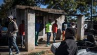 Informal traders and waste-pickers queue at the parking lot of the Orlando East Communal Hall in Soweto, Johannesburg, on April 17, 2020 during a food distribution. AFP / MARCO LONGARI