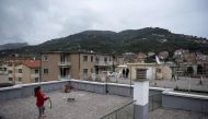 Carola Pessina (foreground) plays tennis with Vittoria Oliveri on the rooftops of their house in Finale Ligure, Liguria Region, northwestern Italy on April 19, 2020, during the country's lockdown aimed at stopping the spread of the COVID-19 (new coronavir