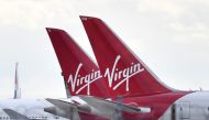 (FILES) In this file photo taken on April 02, 2020 tailfins of parked Virgin Atlantic passenger aircraft are pictured on the apron at Heathrow Airport, west of London. AFP / Ben STANSALL