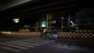 A man wearing a protective face mask rides a bike along an empty road amid the lockdown to contain the coronavirus disease (COVID-19) outbreak in Metro Manila, Philippines, April 21, 2020. REUTERS/Eloisa Lopez