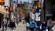 People walk along a shopping street leading to Tsuruoka Hachimangu, a symbolic shrine in Kamakura on April 25, 2020, amid concerns of the COVID-19 coronavirus. / AFP / Kazuhiro NOGI
