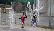 A girl plays in a fountain at the Guggenheim Museum, after restrictions were partially lifted for children for the first time in six weeks, during the coronavirus disease (COVID-19) outbreak in Bilbao, Spain, April 26, 2020. REUTERS/Vincent West
