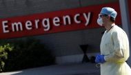 A member of the medical personnel stands at the entrance of the emergency unit at CHIREC Delta Hospital as the spread of the coronavirus disease (COVID-19) continues in Brussels, Belgium April 25, 2020. REUTERS/Yves Herman
