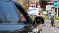 Soldiers give instructions to people in a vehicle at the mobile COVID-19 testing unit, amid the coronavirus disease (COVID-19) outbreak in Salisbury, Britain April 24, 2020. Picture taken April 24, 2020.