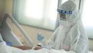 Nurse Tatsanee Onthong, 26, wears personal protective equipment (PPE) as she attends to a COVID-19 in the Emerging Infectious Disease Clinic intensive care unit at King Chulalongkorn Memorial Hospital in Bangkok, Thailand, April 22, 2020. Picture taken Ap