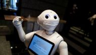 A Pepper humanoid robot, manufactured by SoftBank Group Corp. demonstrates how to check-in in a hotel of APA Group that has been designated to accommodate asymptomatic people and those with light symptoms of the coronavirus disease (COVID-19) to free up h