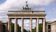 People ride bikes at nearly empty Brandenburg Gate and its surroundings in Berlin, Germany on May 01, 2020.  Abdulhamid Ho?ba? - Anadolu 