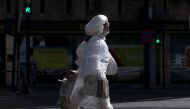 A woman covered in plastic film walks in Granada on May 2, 2020 All Spaniards are again allowed to leave their homes since today to walk or play sports after 48 days of very strict confinement to curb the coronavirus pandemic.  AFP / JORGE GUERRERO