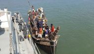 In this picture taken on May 2, 2020, Rohingya refugees stranded at sea are seen on a boat near the coast of Cox's Bazar. Dozens of Rohingya refugees believed to have come from two boats stranded at sea for weeks as they tried to reach Malaysia landed on 