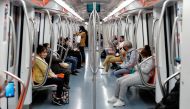 People with protective masks ride on a subway train, as Italy begins a staged end to a nationwide lockdown due to the spread of the coronavirus disease (COVID-19), in Rome, Italy May 4, 2020. REUTERS/Remo Casilli