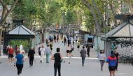 People exercise along Las Ramblas in Barcelona, on May 2, 2020, during the hours allowed by the government to exercise, for the first time since the beginning of a national lockdown to prevent the spread of the COVID-19 disease. / AFP / PAU BARRENA