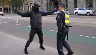 A police officer approaches a protester opposing lockdown measures implemented to curb the spread of the coronavirus disease (COVID-19) outside Parliament House in Melbourne, Australia, May 10, 2020. AAP Image/Scott Barbour via REUTERS 