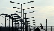 A man runs at a bridge near the Olympic park in Munich, southern Germany, on May 9, 2020, amid the novel coronavirus Covid-19 pandemic. / AFP / Christof Stache 